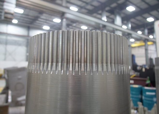 Close-up photograph highlighting the impeccable surface finish and precision engineering of a machined metal component, demonstrating superior manufacturing quality with smooth contours and perfect detailing