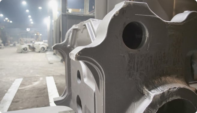 Massive industrial steel casting component manufactured for heavy machinery or infrastructure applications. The substantial metal part showcases precision foundry work where molten steel was poured into a mold and solidified into its final form.
