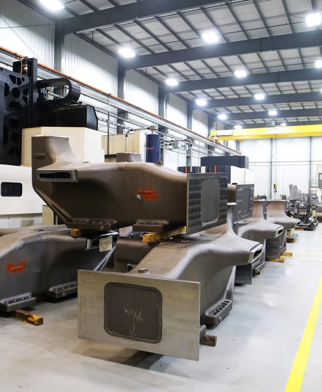 Modern machining facility featuring a spacious, well-lit white room housing various precision manufacturing equipment.
