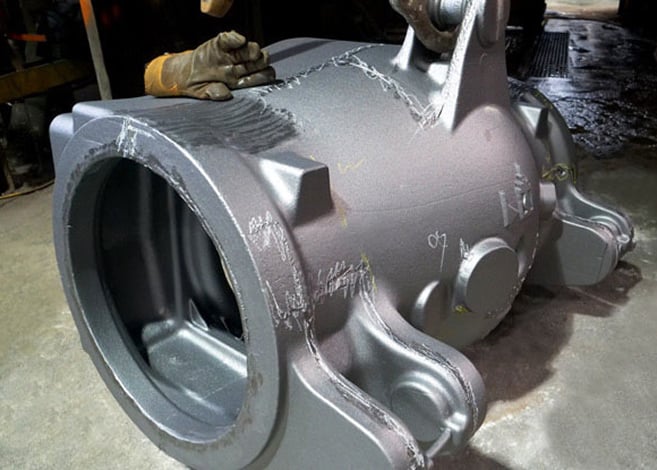 A massive work glove rests on one of Harrison Steel's recent castings for a customer.